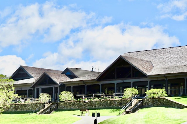 exterior space featuring a front lawn and stairway