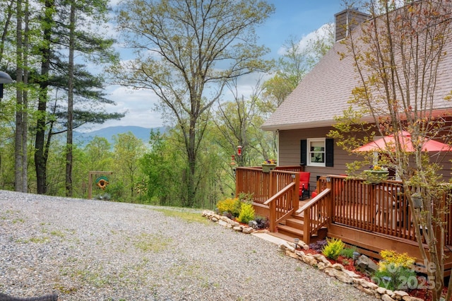 exterior space with a deck with mountain view