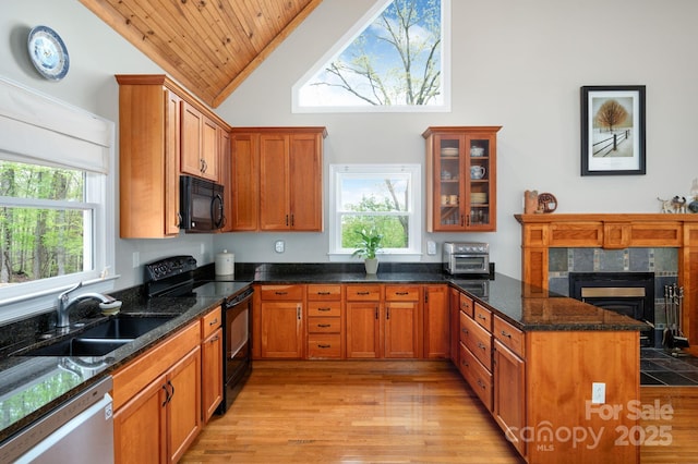 kitchen featuring a sink, high vaulted ceiling, a peninsula, wood ceiling, and black appliances