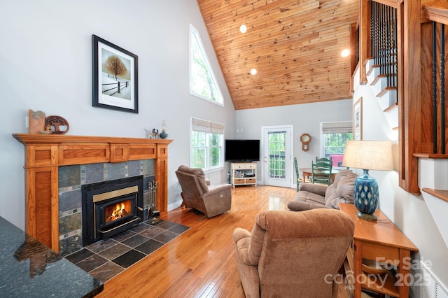 living room featuring a fireplace, stairway, wooden ceiling, high vaulted ceiling, and hardwood / wood-style floors