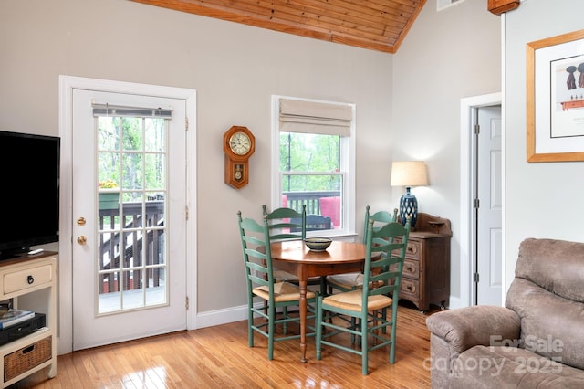 dining room with visible vents, vaulted ceiling, wooden ceiling, baseboards, and light wood finished floors