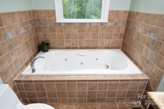 full bathroom with a jetted tub and toilet