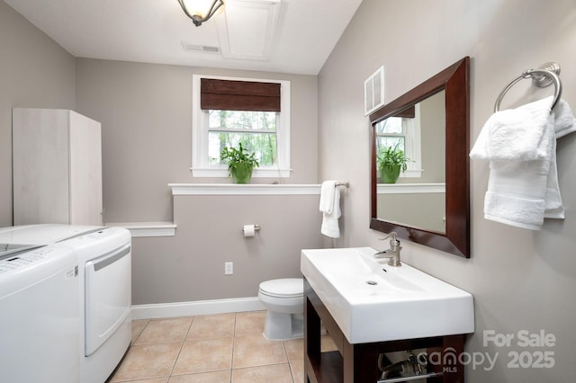 bathroom with separate washer and dryer, tile patterned flooring, visible vents, and toilet