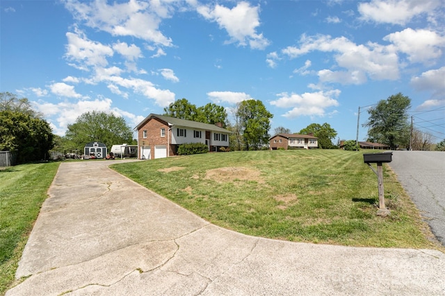 ranch-style home featuring a front yard, brick siding, a garage, and driveway