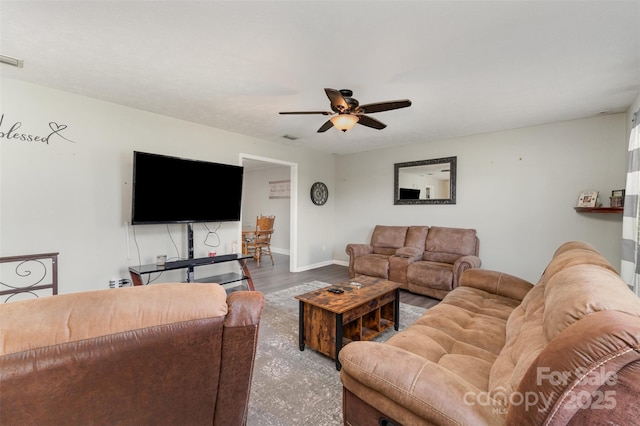 living room featuring visible vents, ceiling fan, wood finished floors, and baseboards