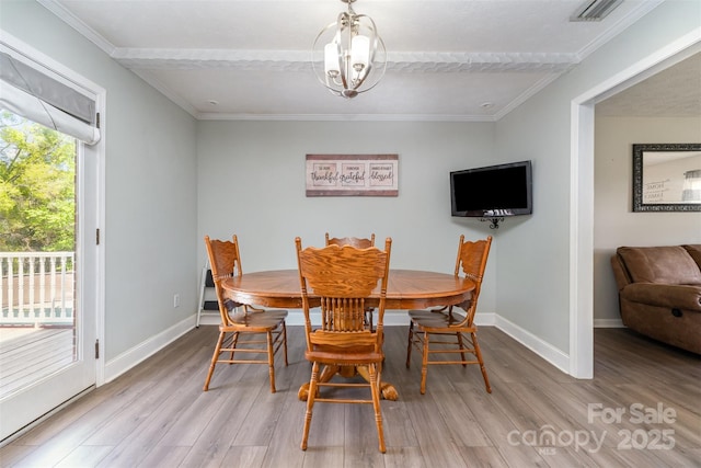 dining area featuring ornamental molding, visible vents, baseboards, and wood finished floors