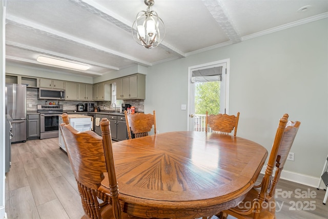 dining area featuring baseboards, an inviting chandelier, light wood-type flooring, crown molding, and beamed ceiling