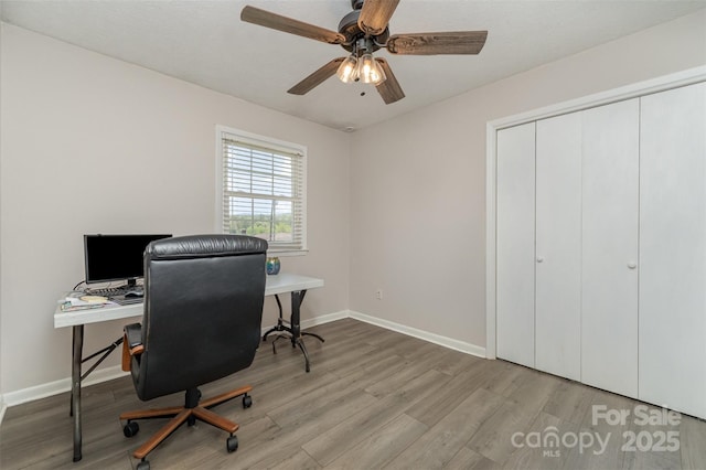 office area featuring wood finished floors, ceiling fan, and baseboards