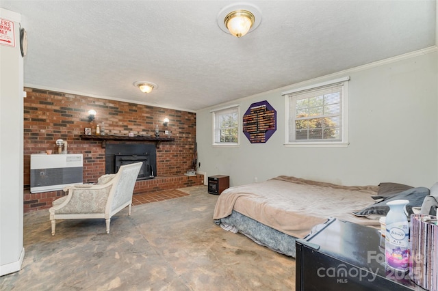 bedroom with heating unit, a textured ceiling, crown molding, concrete flooring, and a fireplace