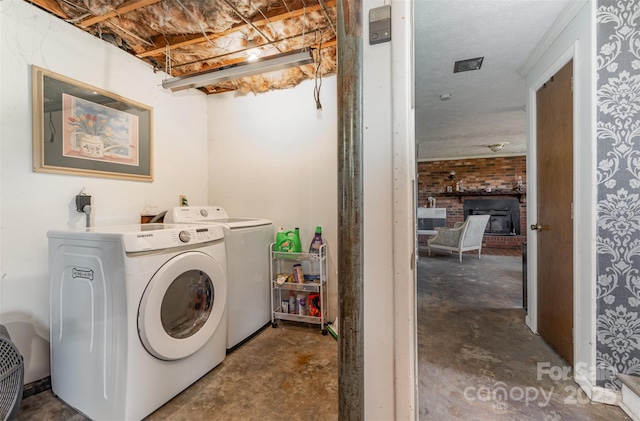 clothes washing area with washer and clothes dryer and laundry area