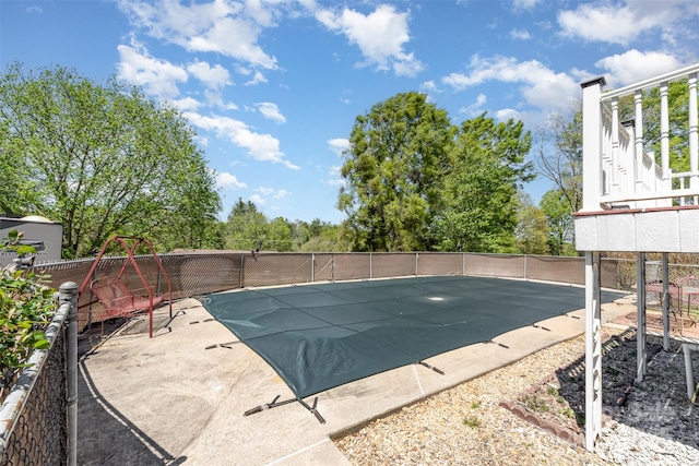 view of swimming pool featuring a patio area, fence, and a fenced in pool