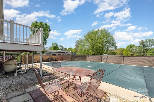 view of pool featuring fence and community basketball court