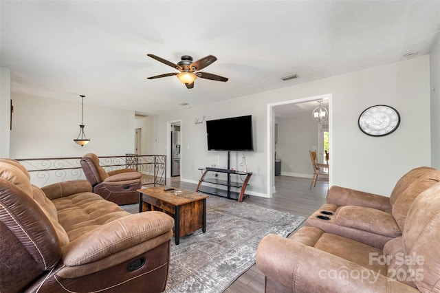 220 Hilltop St, Connelly Springs, NC 28612 - living room featuring wood finished floors, a ceiling fan, baseboards, and a chandelier