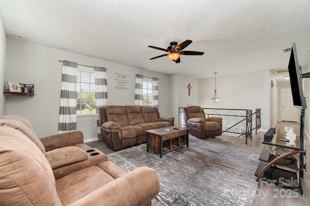 220 Hilltop St, Connelly Springs, NC 28612 - living room with wood finished floors, ceiling fan, and baseboards