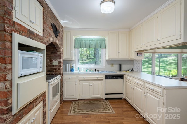 1058 General Hoke Dr, Lincolnton, NC 28092 - kitchen featuring a sink, wood finished floors, white appliances, light countertops, and a peninsula