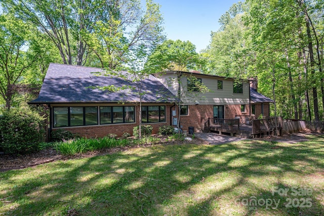 1058 General Hoke Dr, Lincolnton, NC 28092 - back of property featuring a lawn, brick siding, and a deck