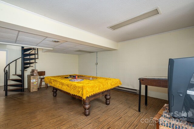 1058 General Hoke Dr, Lincolnton, NC 28092 - game room featuring a baseboard heating unit, wood finished floors, and concrete block wall