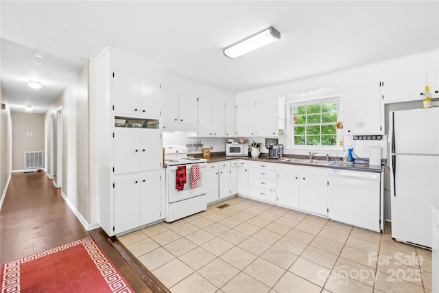 1204 Meadowood Dr, Shelby, NC 28150 - kitchen featuring white appliances, white cabinets, visible vents, a sink, and dark countertops