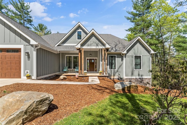 44 Sycamore Dr, Nebo, NC 28761 - view of front facade with an attached garage, driveway, board and batten siding, and a shingled roof