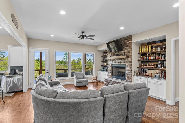 44 Sycamore Dr, Nebo, NC 28761 - living room with light wood-type flooring, a dry bar, ceiling fan, and a fireplace
