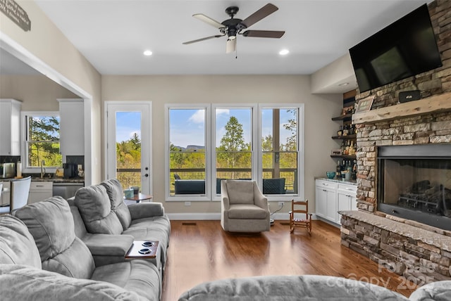 44 Sycamore Dr, Nebo, NC 28761 - living room with wood finished floors, ceiling fan, a stone fireplace, and recessed lighting