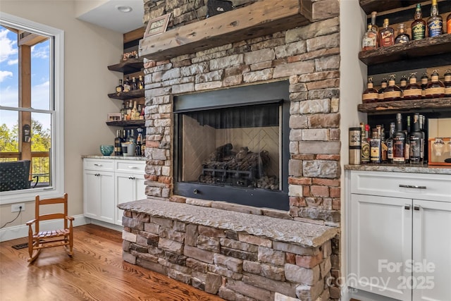 44 Sycamore Dr, Nebo, NC 28761 - interior details with a bar, a fireplace, baseboards, and wood finished floors