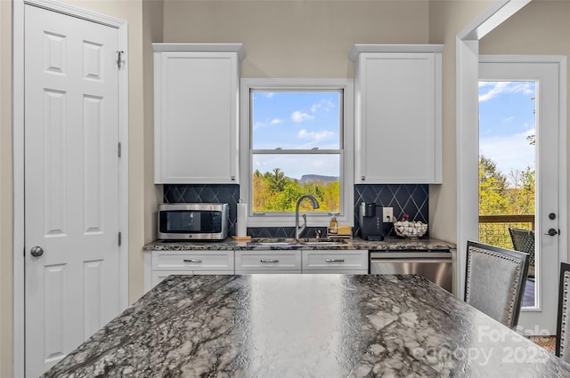 44 Sycamore Dr, Nebo, NC 28761 - kitchen featuring tasteful backsplash, white cabinets, and stainless steel appliances