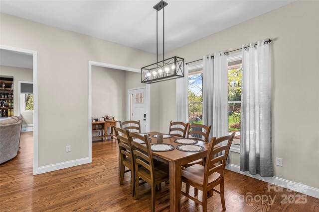 44 Sycamore Dr, Nebo, NC 28761 - dining space with baseboards, a chandelier, and wood finished floors