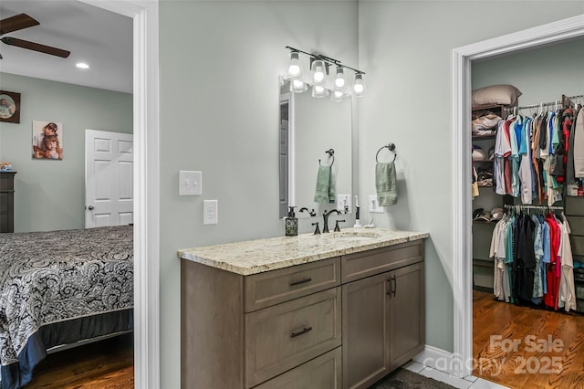 44 Sycamore Dr, Nebo, NC 28761 - bathroom with ceiling fan, vanity, recessed lighting, wood finished floors, and a walk in closet