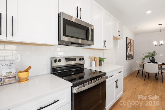 kitchen featuring light countertops, white cabinetry, and appliances with stainless steel finishes