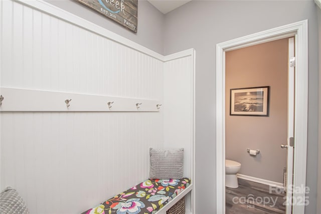 mudroom featuring baseboards and wood finished floors