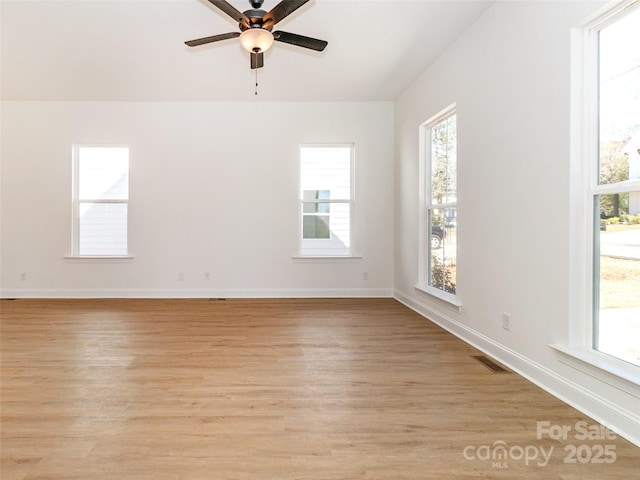 2501 Elon St, Charlotte, NC 28208 - empty room featuring light wood-style flooring, a ceiling fan, and baseboards
