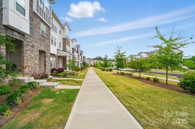 view of home's community with a lawn and a residential view