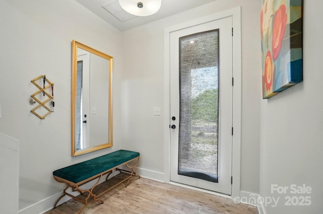 entryway featuring baseboards and wood finished floors