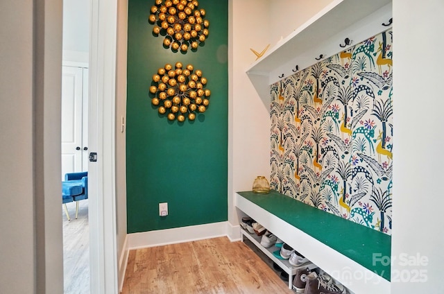 mudroom featuring baseboards and wood finished floors