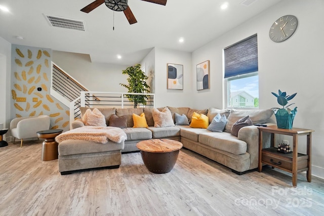 living room featuring visible vents, stairs, wood finished floors, ceiling fan, and recessed lighting