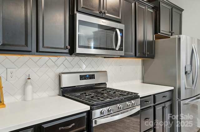 kitchen with light countertops, backsplash, and stainless steel appliances