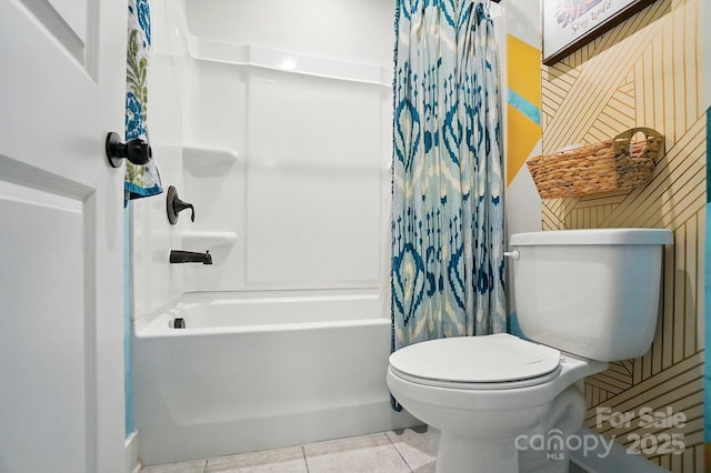 bathroom featuring shower / tub combo with curtain, tile patterned floors, and toilet