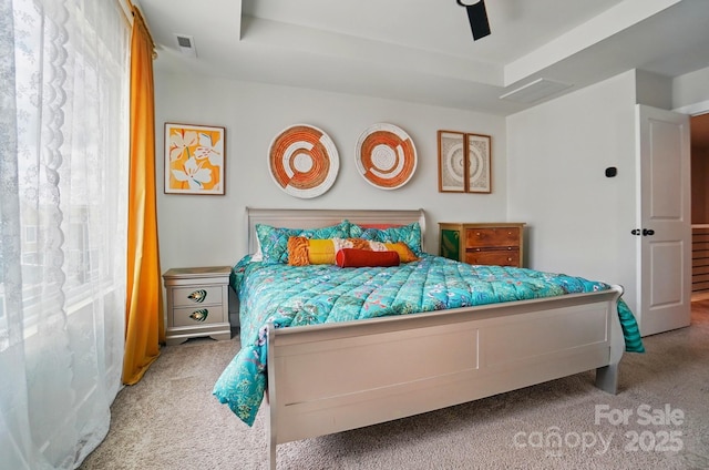 bedroom featuring carpet floors, a ceiling fan, and visible vents