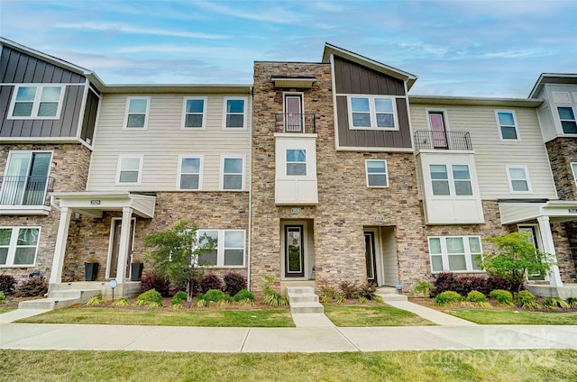 townhome / multi-family property with board and batten siding and stone siding