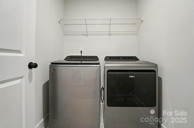clothes washing area with laundry area and washer and clothes dryer