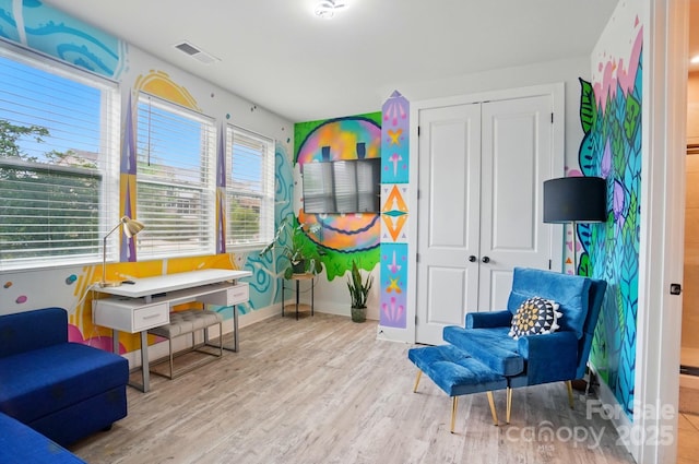 playroom featuring visible vents, baseboards, and wood finished floors