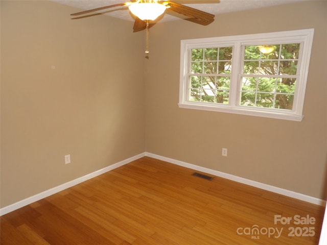 106 Pinetree Dr, Black Mountain, NC 28711 - unfurnished room with wood finished floors, visible vents, ceiling fan, and baseboards
