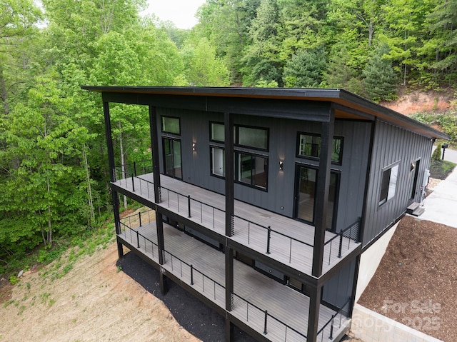 175 Silverglen Way, Hendersonville, NC 28792 - exterior space featuring a view of trees, board and batten siding, and a deck
