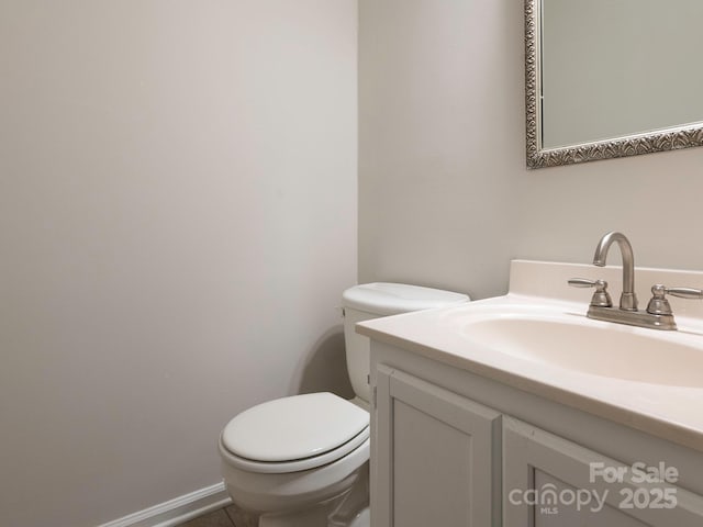 bathroom with toilet and vanity