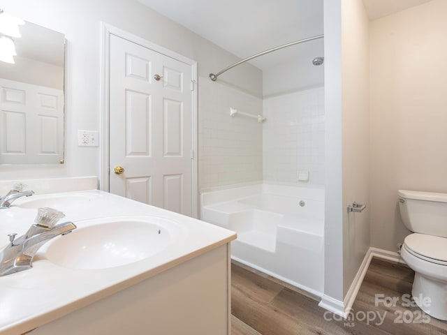 bathroom with shower / bathtub combination, a sink, toilet, and wood finished floors