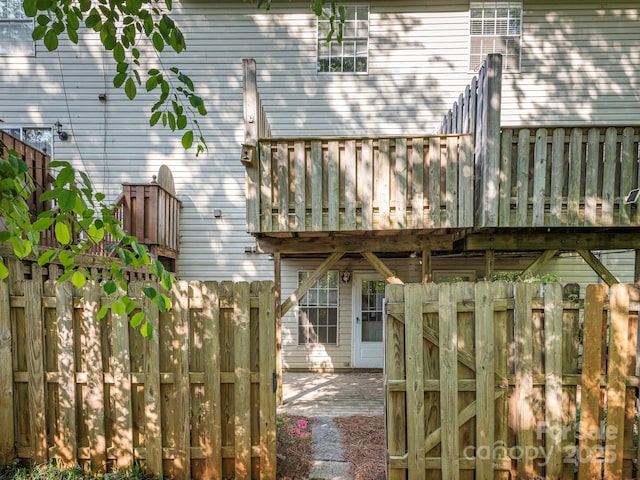 rear view of property featuring fence and a balcony
