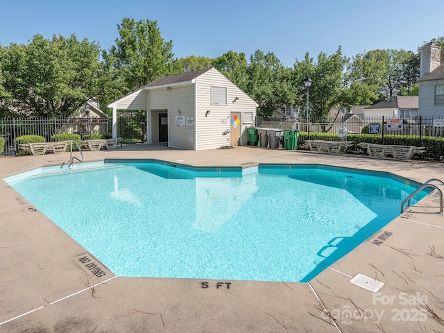 pool featuring a patio and fence