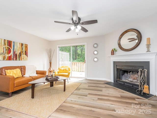 1203 Maple Shade Ln, Charlotte, NC 28270 - living room featuring light wood-style flooring, a ceiling fan, baseboards, and a fireplace with flush hearth