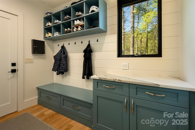 mudroom with light wood finished floors and baseboards